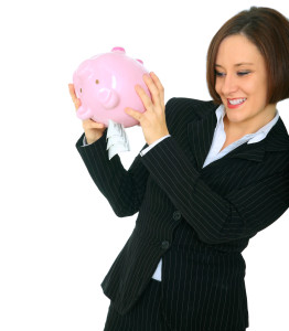 woman shaking piggy bank