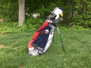 Golf bag standing on a grassy fairway, symbolizing practical financial planning for retirements "back nine."