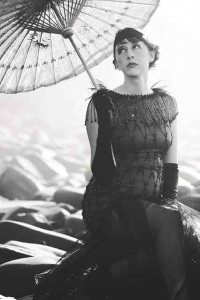 Women in a flapper dress holding a parasol, evoking the spirit of the Roaring Twenties
