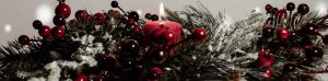 Candle with evergreens and cranberries.