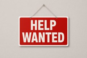 Help Wanted sign representing the need for assistance in a small business