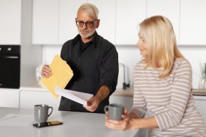 Medicare-eligible couple reviewing a letter about increased Medicare premiums